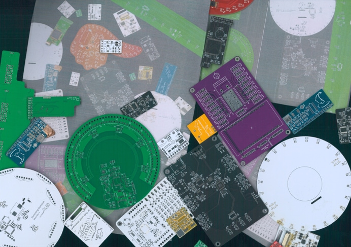 Circuit boards of various colours stacked together with their own scan images.