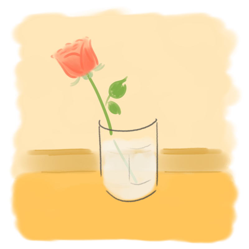 A rose placed in a transparent container in a shaded area on the balcony.